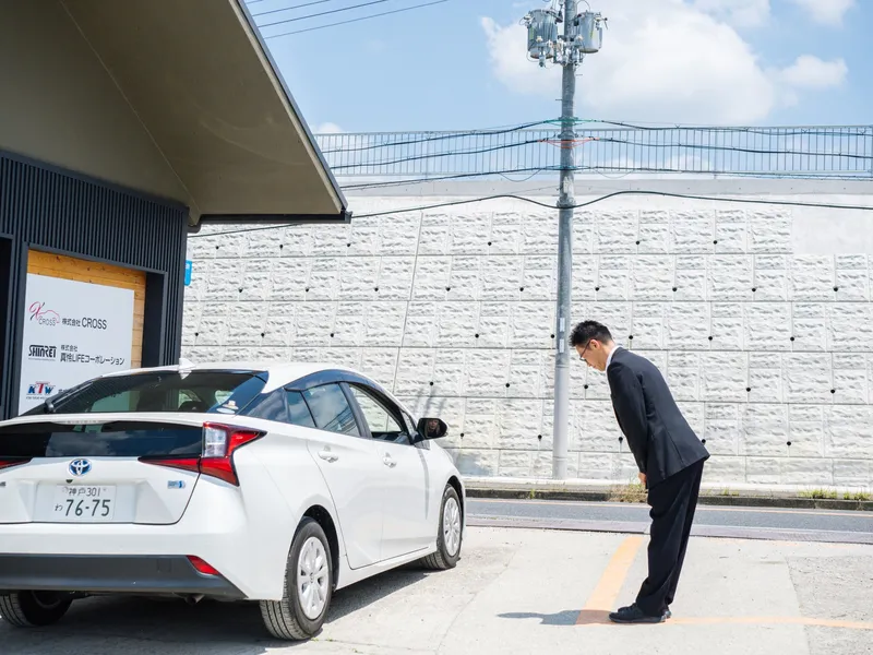 納車したお車をお見送りするスタッフ